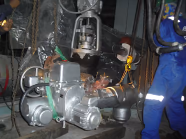 KEI technicians rigging an actuator onto a valve assembly during installation